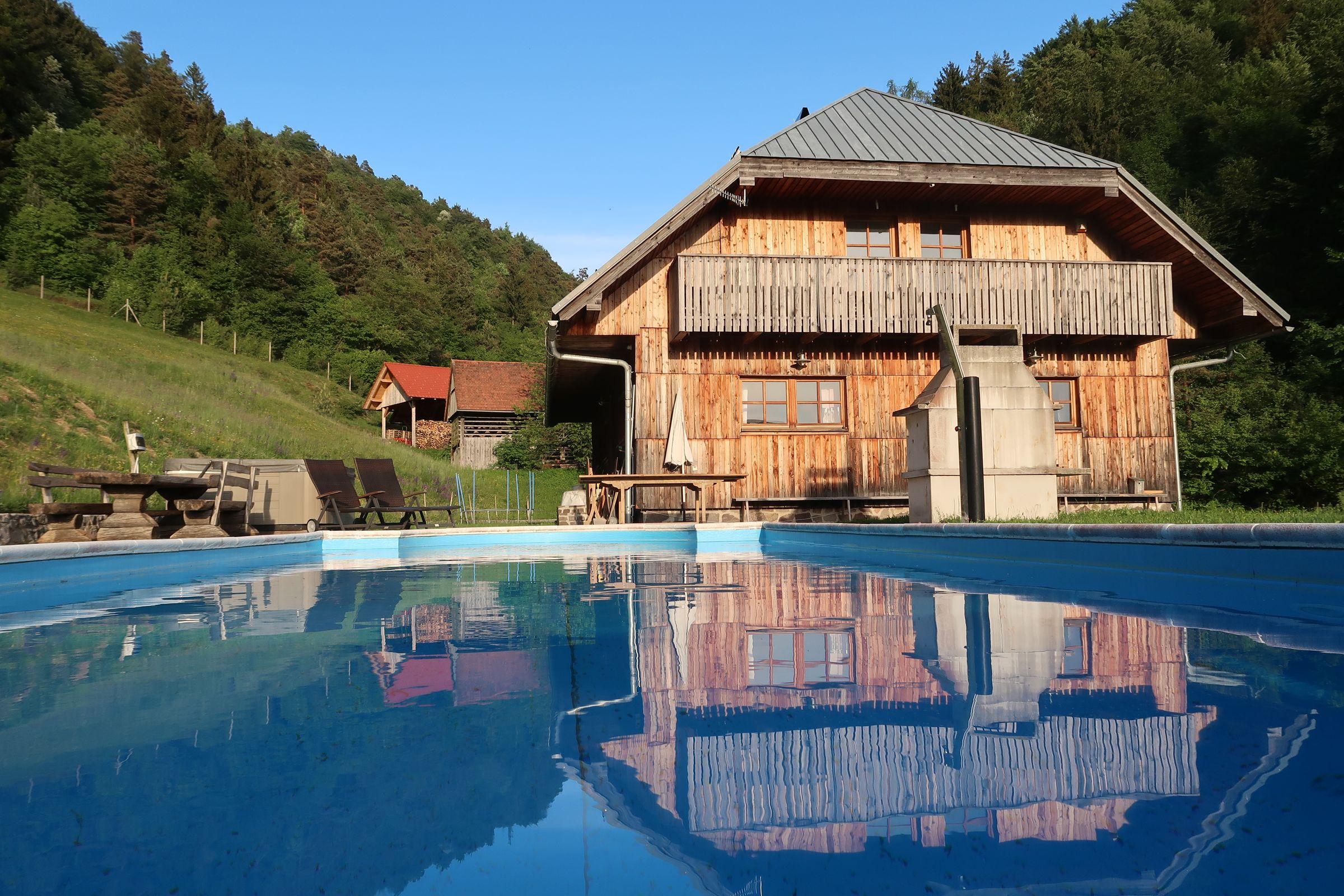 Pool in front of the timber house at Forest Farmstay